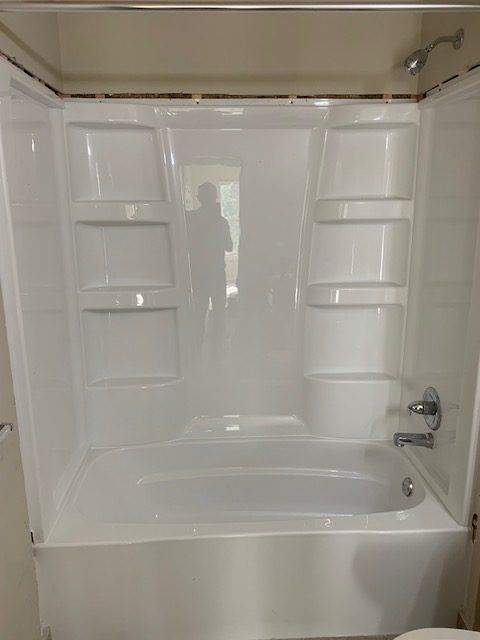 Finished tub and surround in a renovated apartment bathroom