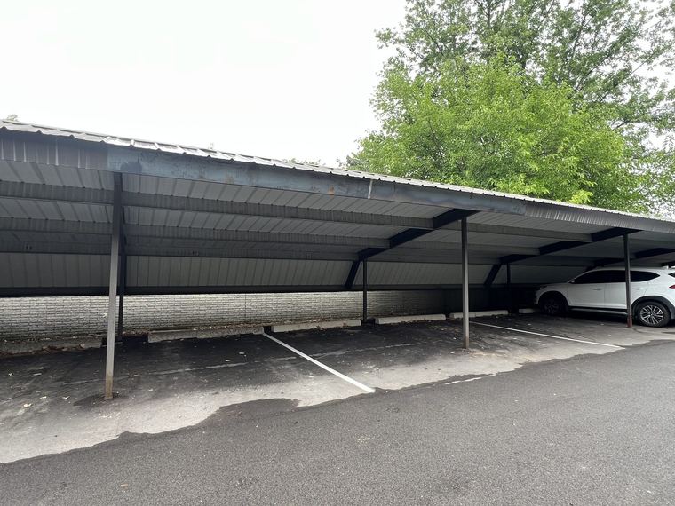 Steel carport canopy over resident parking