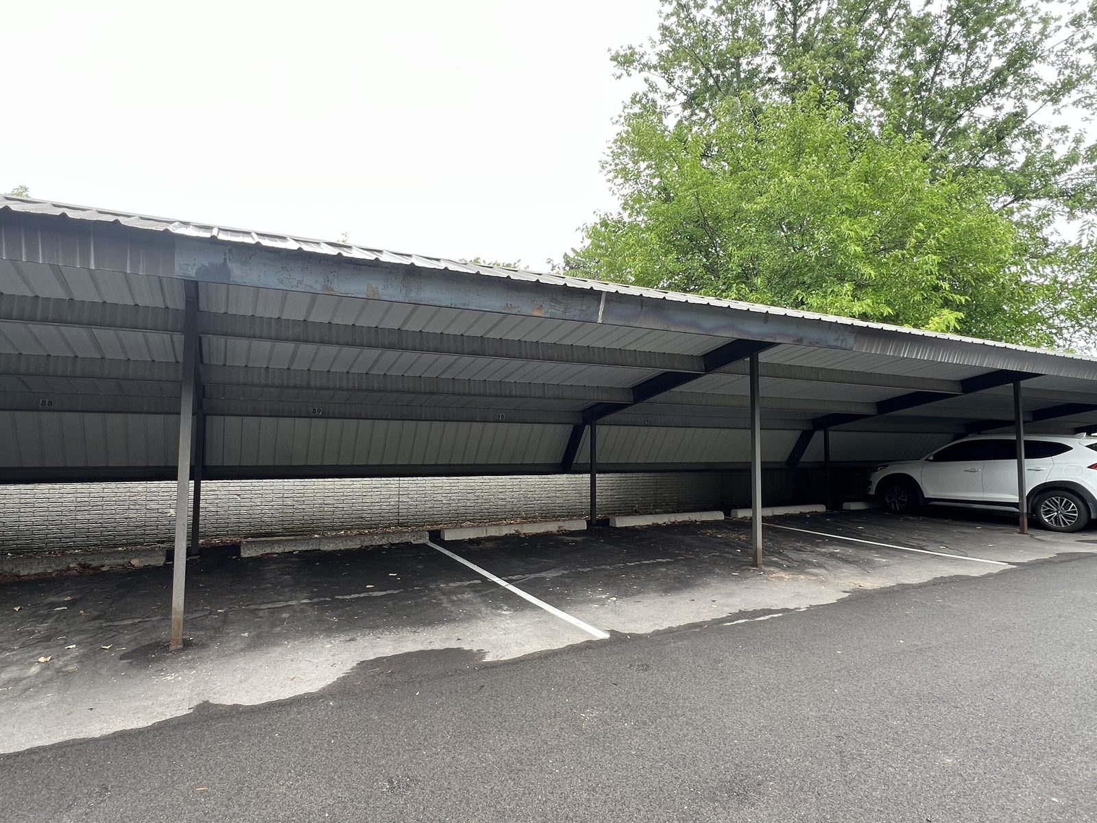 Steel carport canopy over resident parking