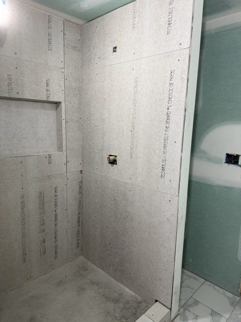 Cement board set in a shower before tile
