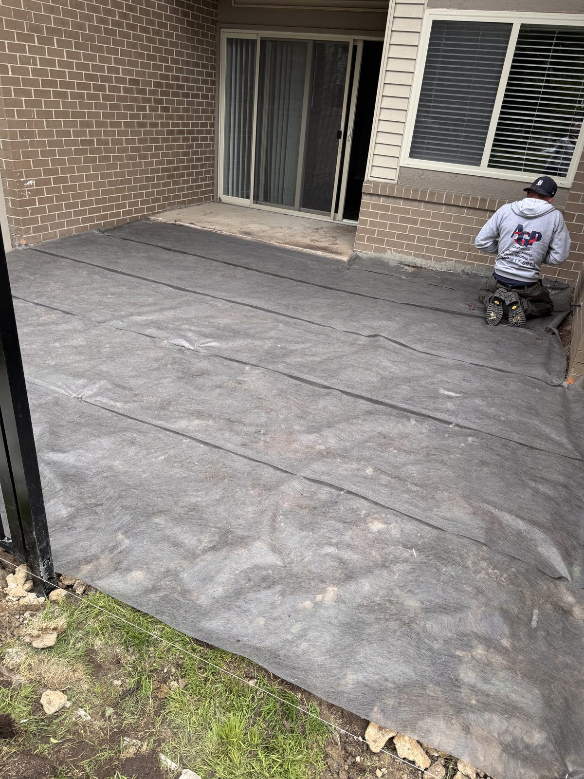 Concrete patio and walkway at a ground-floor unit