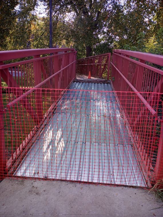 Metal deck and safety railing on an access ramp