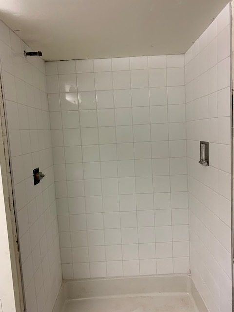 Finished tiled shower in a renovated unit