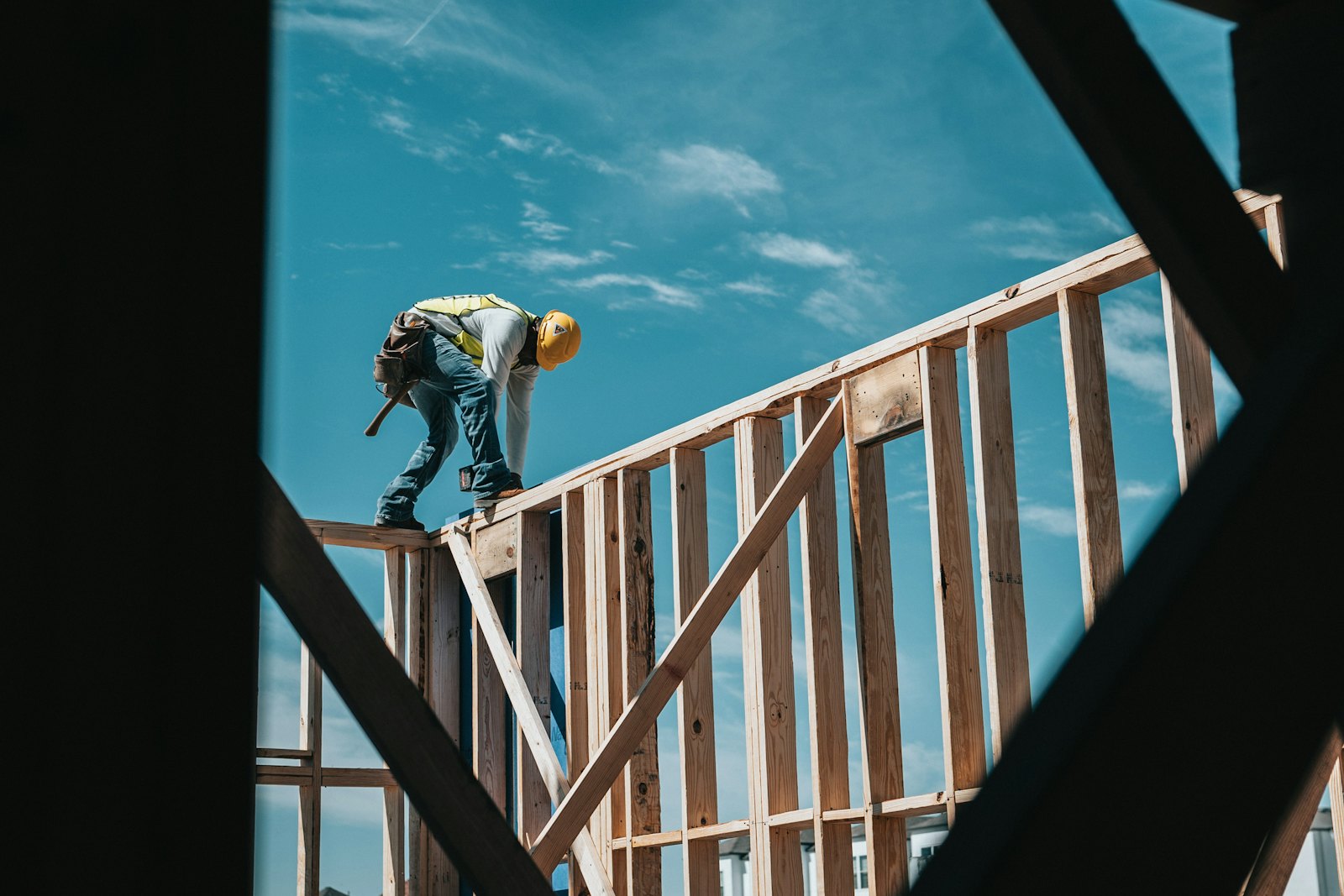 Crew member working at roof level on a wood frame